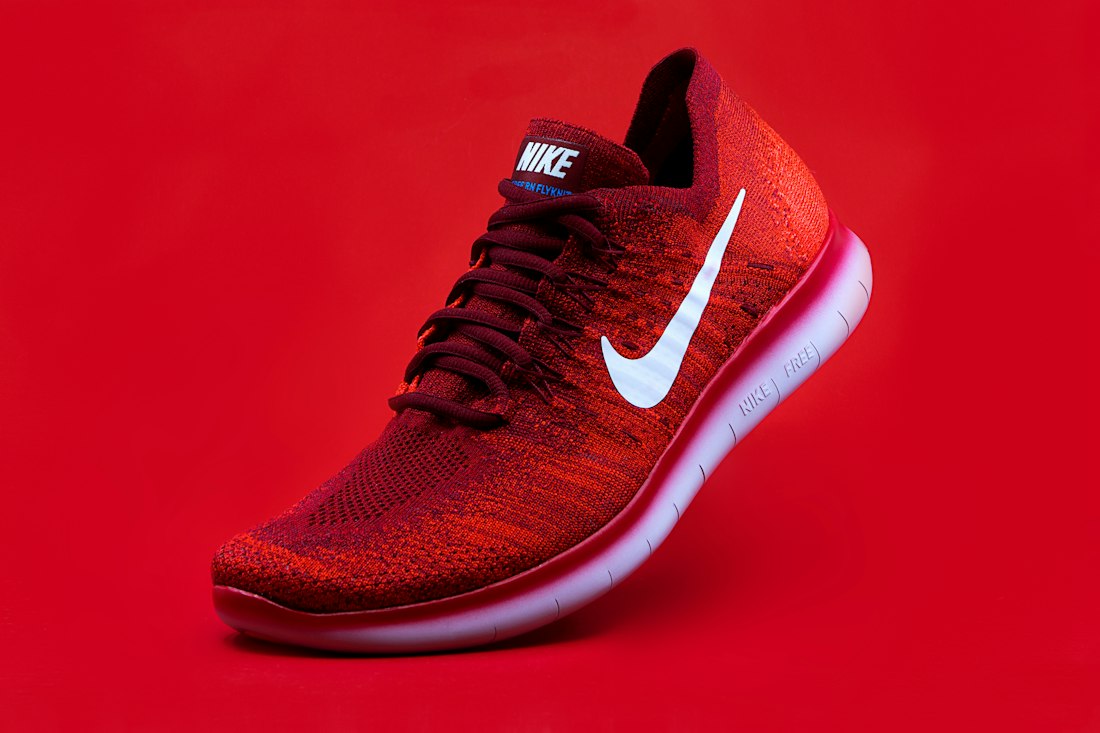 Illustrative red-and-black running shoe product image