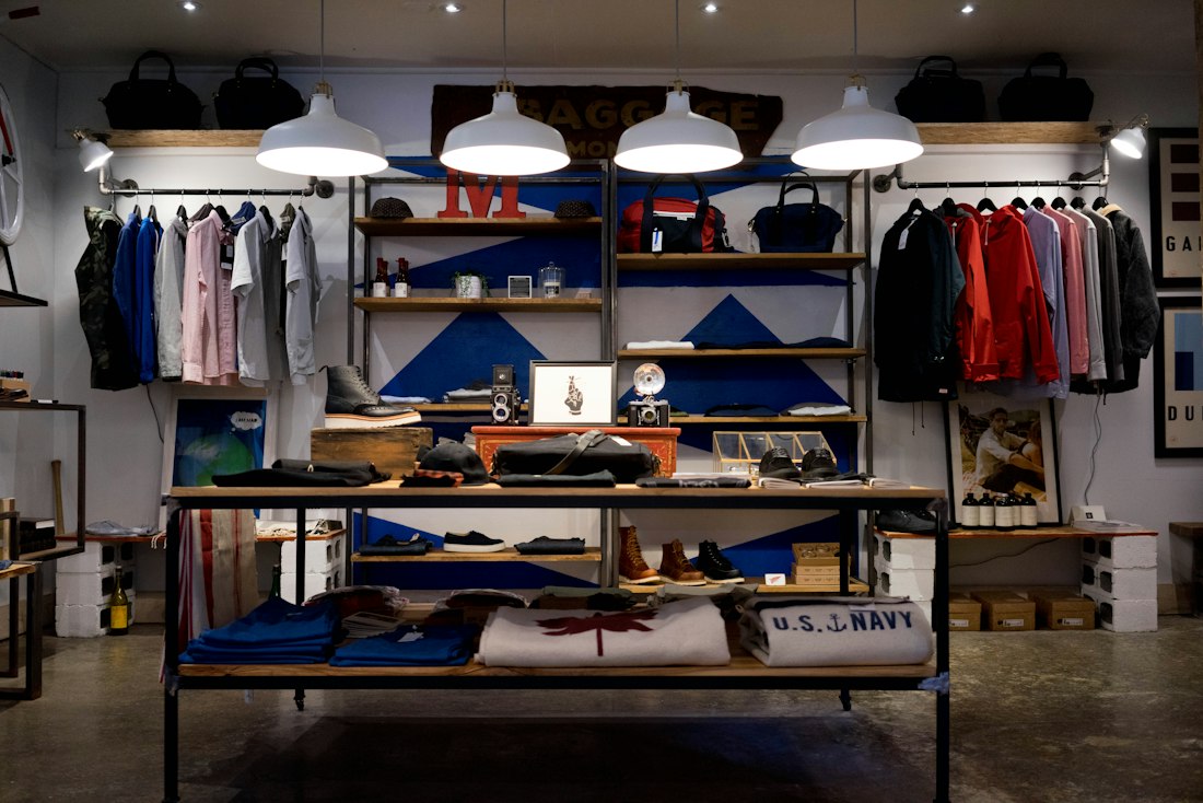 Illustrative black footwear retail interior with red neon lighting